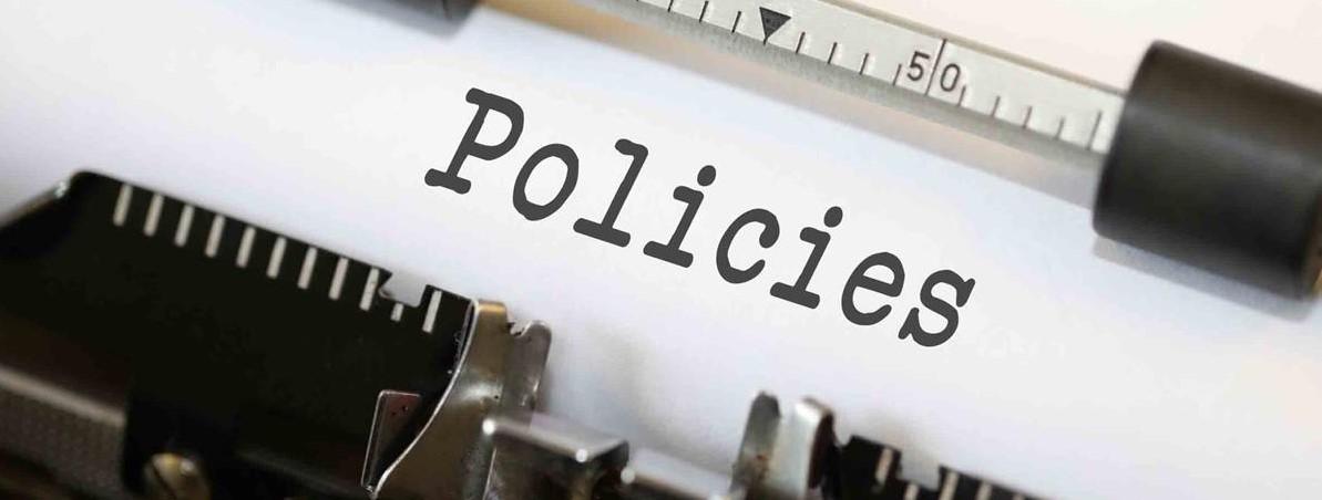 Typewriter with heading Policies displayed